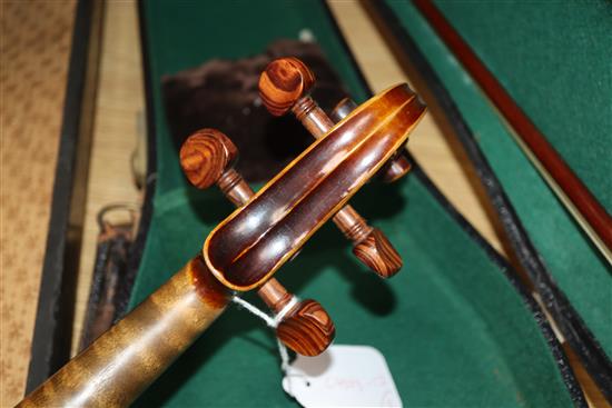 A German Strad style violin and a small violin and two bows